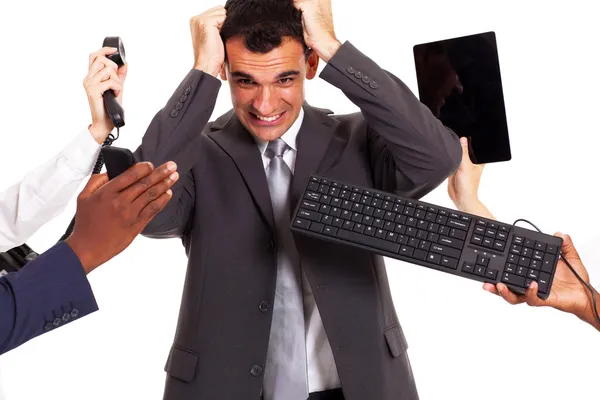 Frustrated businessman around by multiple office tools — Stock Photo, Image