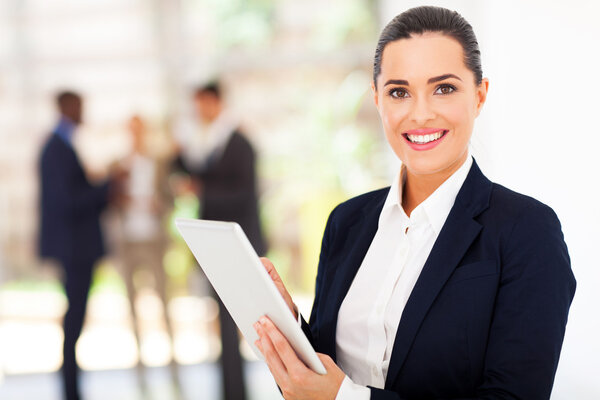 beautiful female corporate worker with tablet computer in office