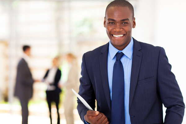 handsome african american businessman with tablet computer in office