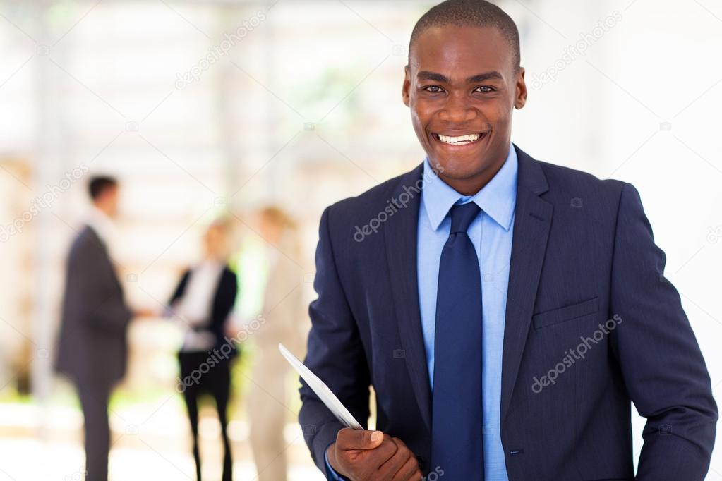 handsome african american businessman with tablet computer in office