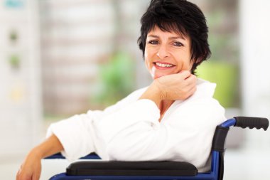 Middle aged woman sitting on wheelchair