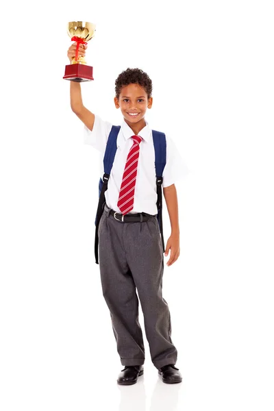 Cute elementary schoolboy holding a trophy isolated on white — Stock Photo, Image