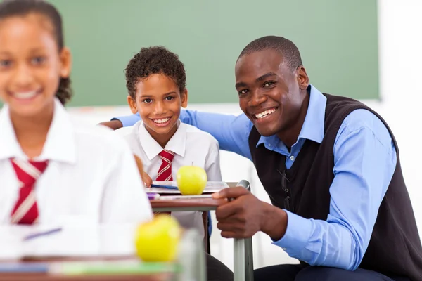 African elementary school teacher and students in classroom Stock Image