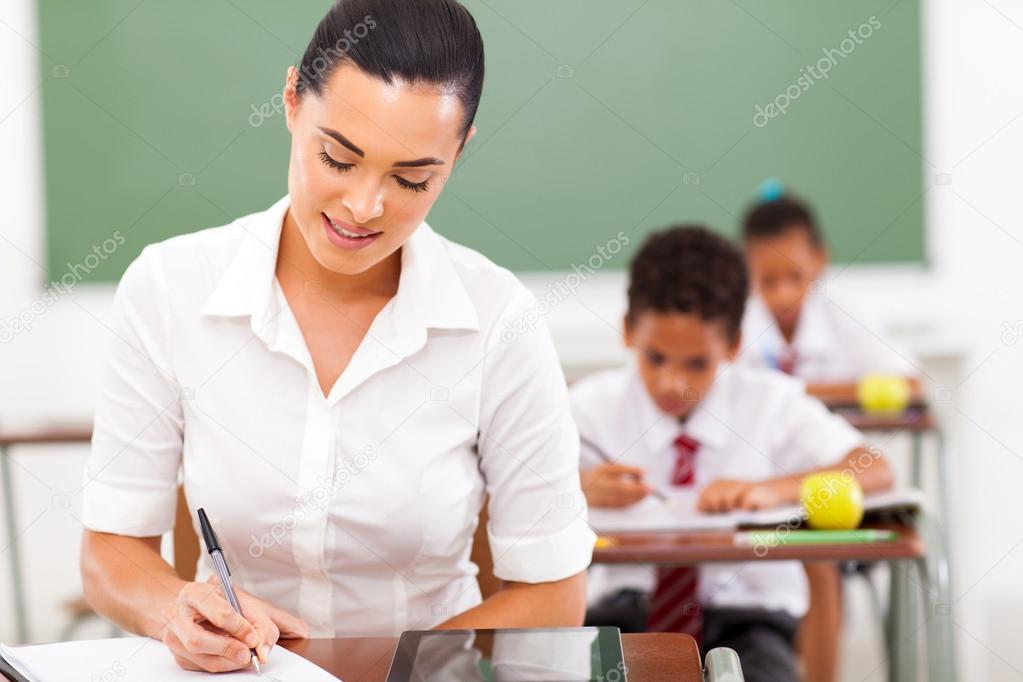 teacher preparing lessons in classroom