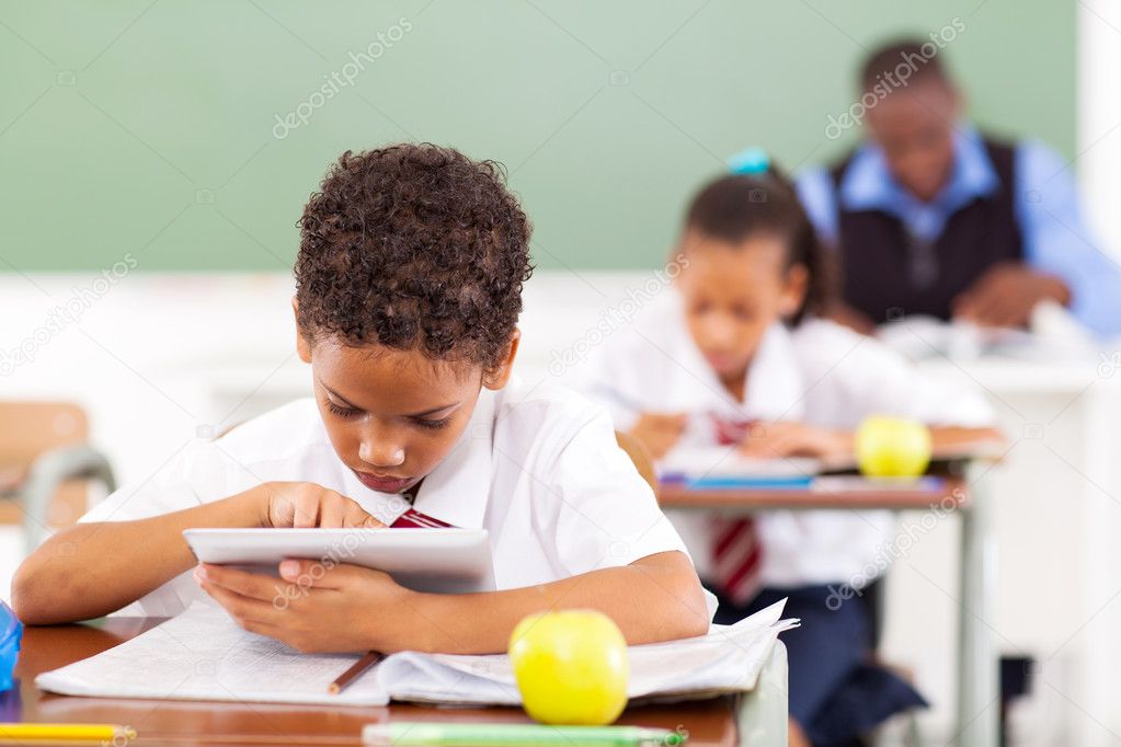 elementary schoolboy using a tablet computer