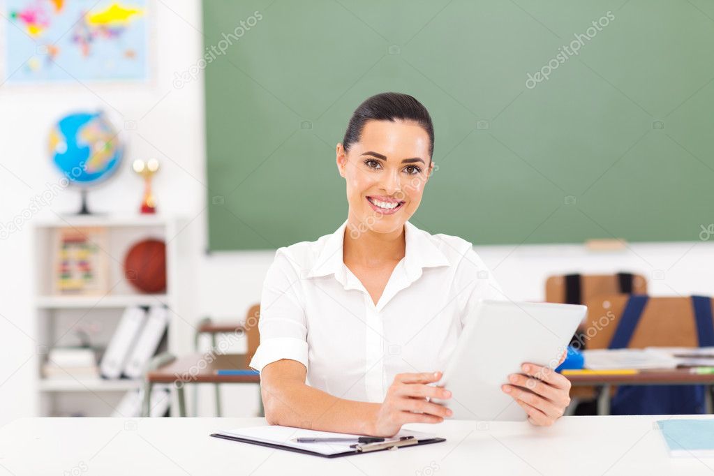 female teacher holding a tablet computer