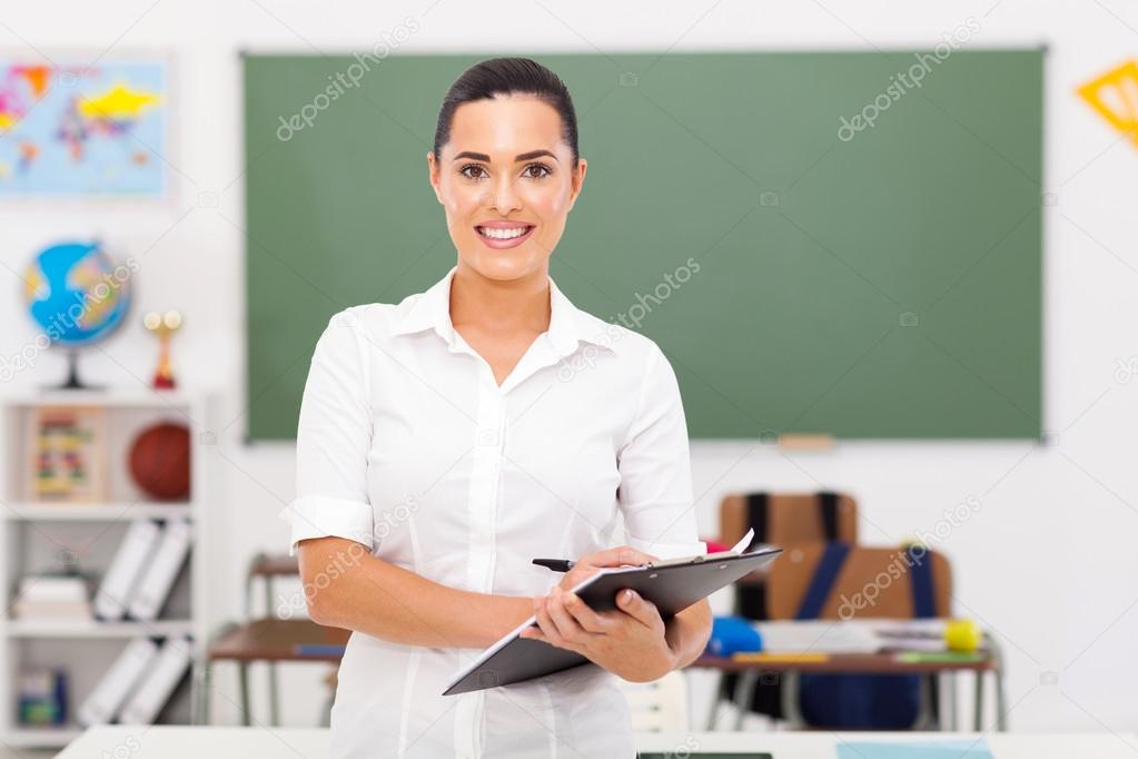 elementary school teacher standing in classroom