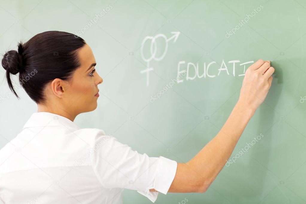 educator writing sex education on chalkboard