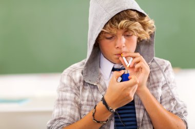 teen boy lighting cigarette clipart