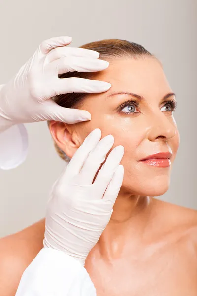 Skin check on mid age woman face — Stock Photo, Image