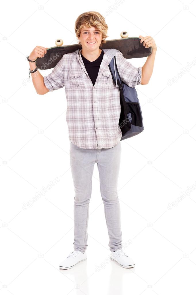 Happy teen boy carrying skateboard
