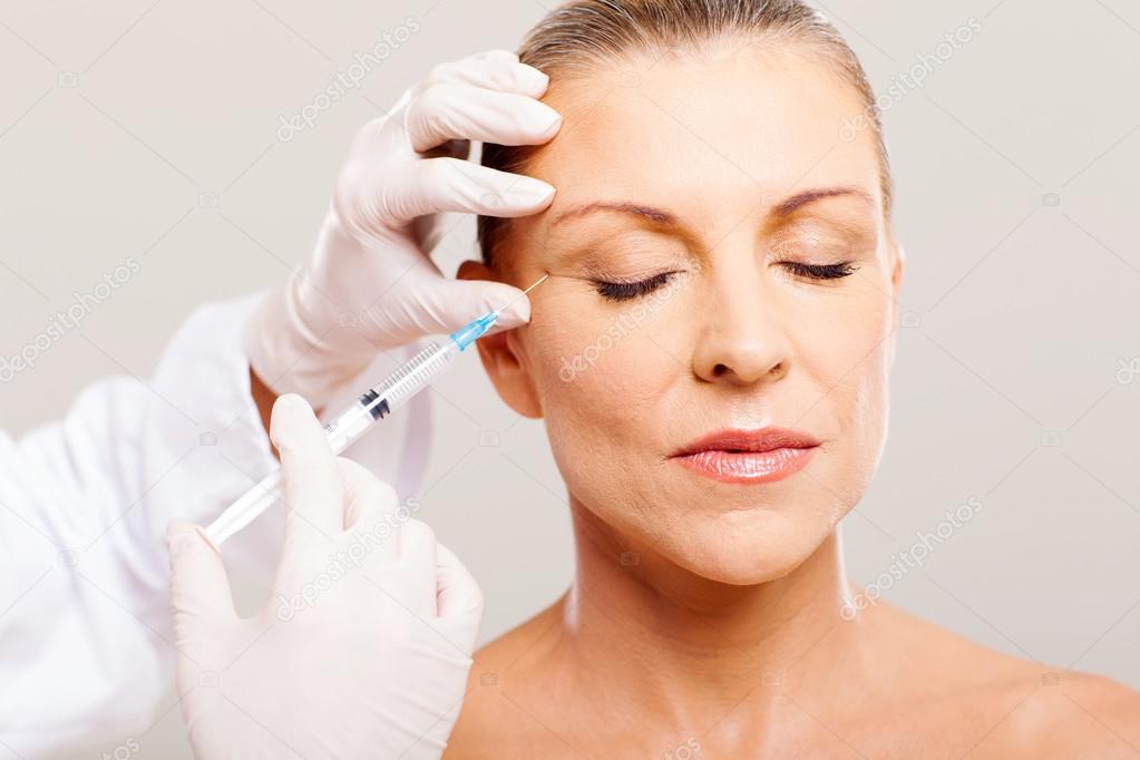 Beautician giving face lifting injection