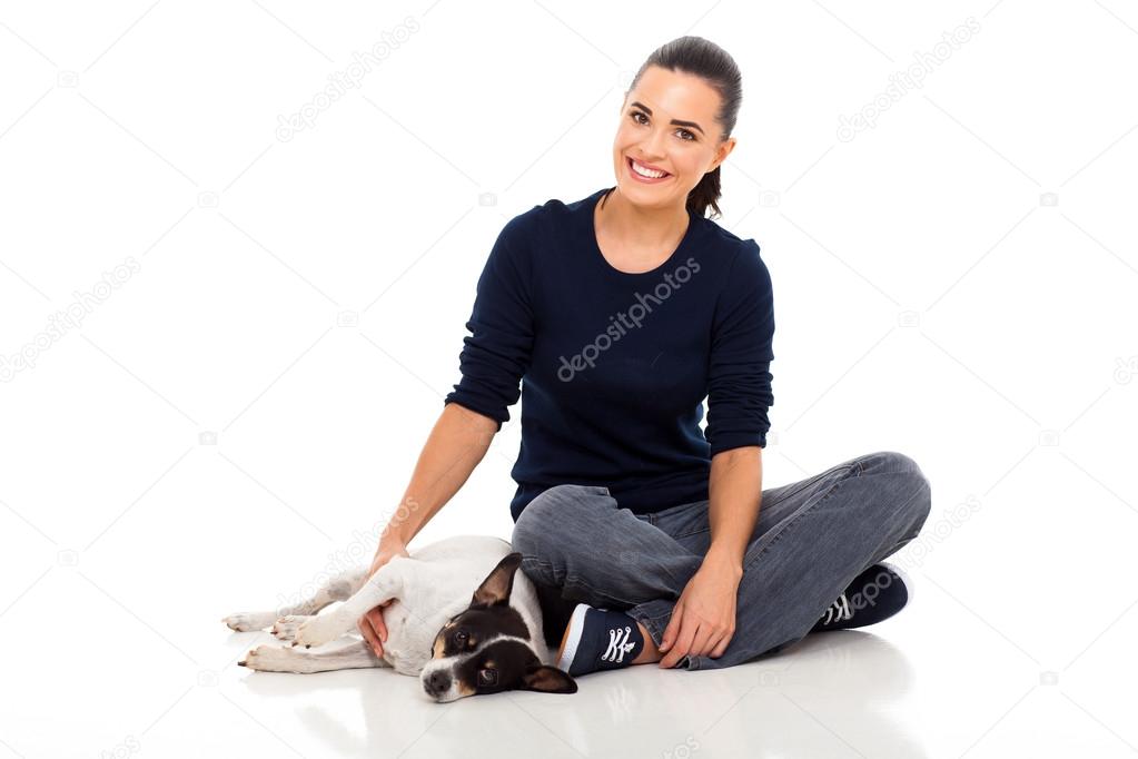 young woman sitting on floor with her dog