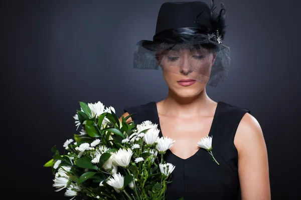 Widow with flowers — Stock Photo, Image