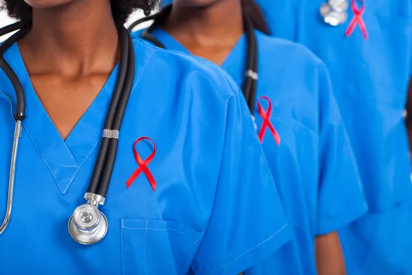 African medical doctors with red ribbon — Stock Photo, Image