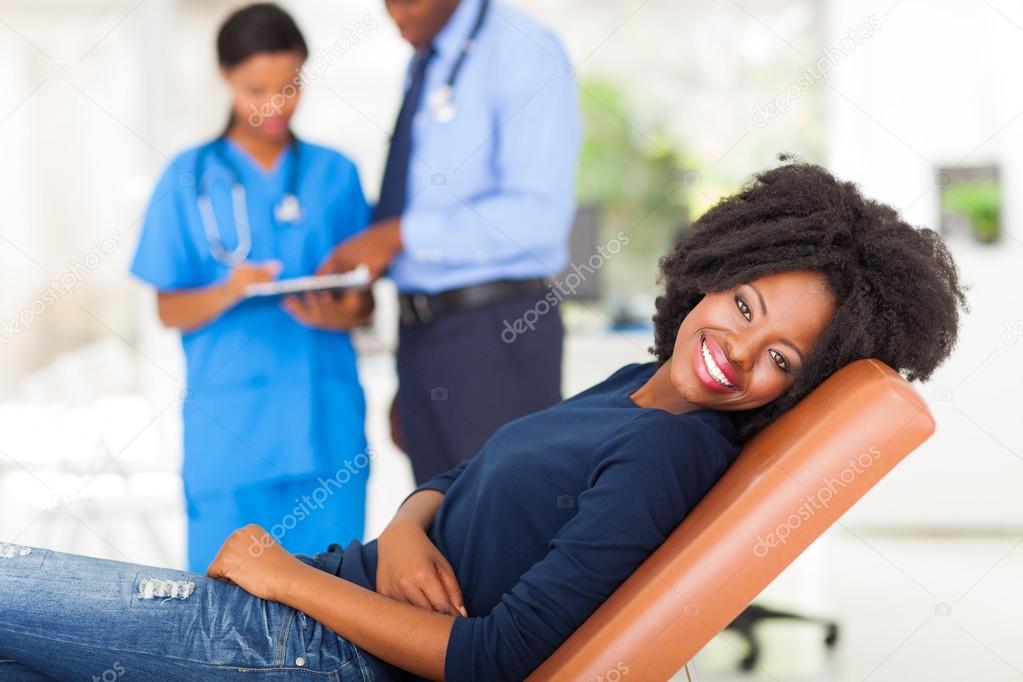 happy african woman waiting for medical checkup