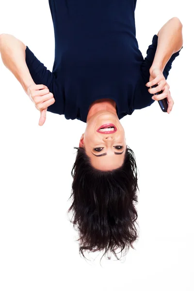 Woman holding smart phone and giving thumb up upside down — Stok fotoğraf