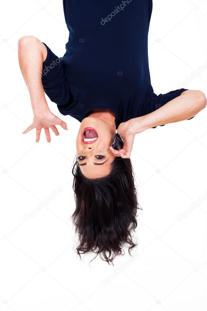 woman talking on cellphone upside down