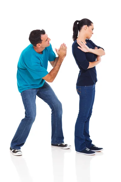 Man begging his angry wife Stock Photo