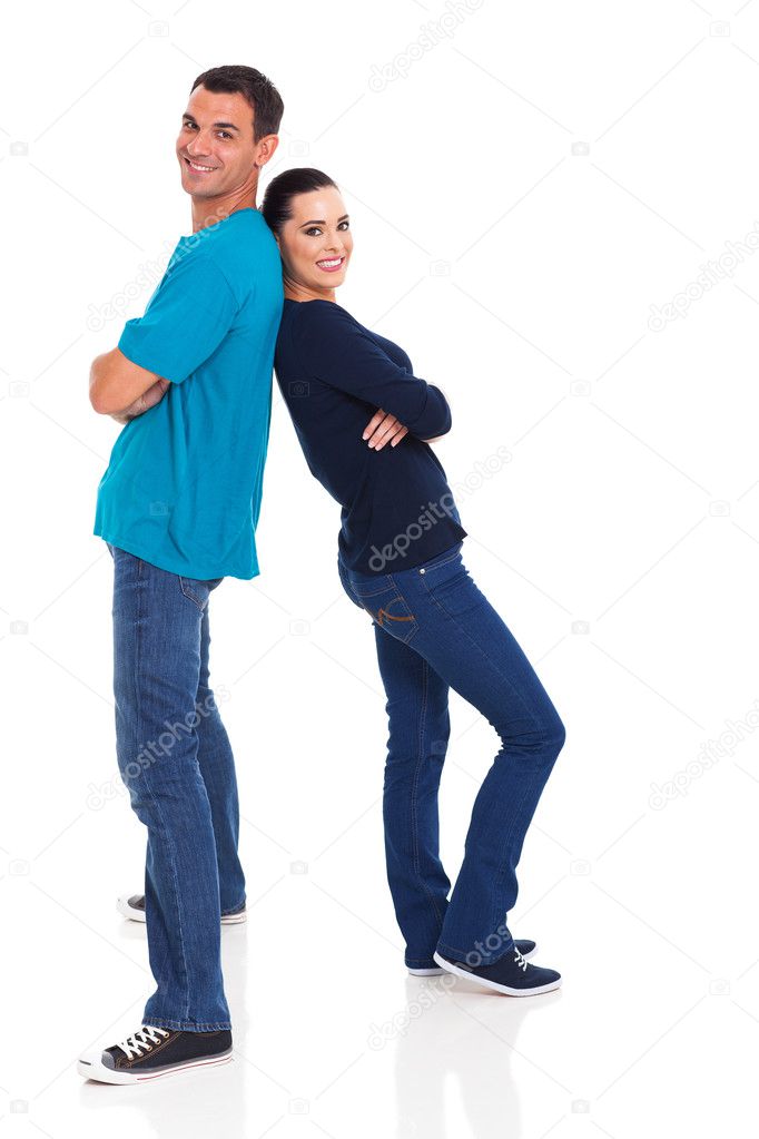 young couple standing back to back