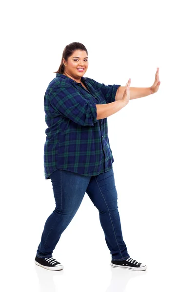 Pretty plus size teenage girl pushing on empty copyspace — Stock Photo, Image