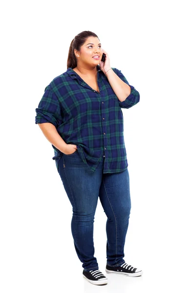 Young plus size woman talking on cell phone and looking up — Stock Photo, Image