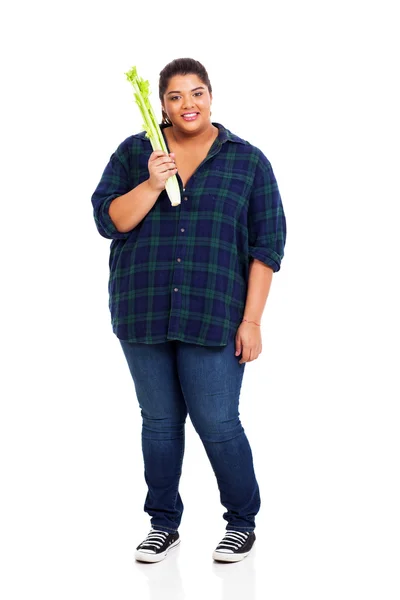 Plus size teenager holding celery — Stock Photo, Image