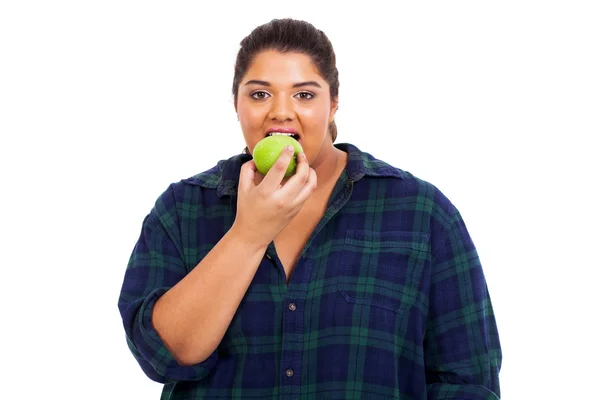 Plus size young woman biting an apple Stock Photo