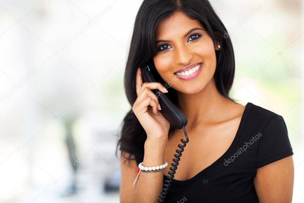 gorgeous young businesswoman answering telephone