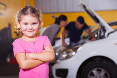cute little girl waiting for mother in garage clipart