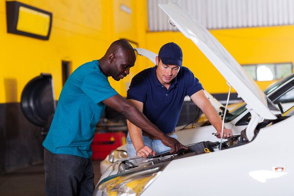 african man showing auto mechanic car problem
