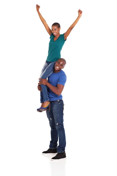 Happy african woman sitting on her boyfriend's shoulder — Stock Photo, Image