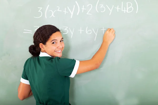 Estudante sorrindo escrevendo matemática no quadro negro — Fotografia de Stock