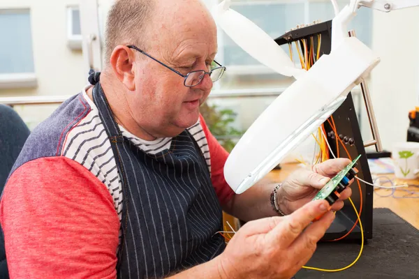 Senior technician checking electrical circuit board — Stock Photo, Image