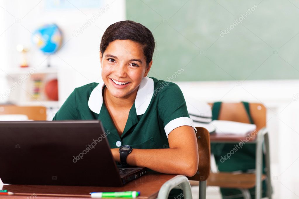 female middle school student using laptop