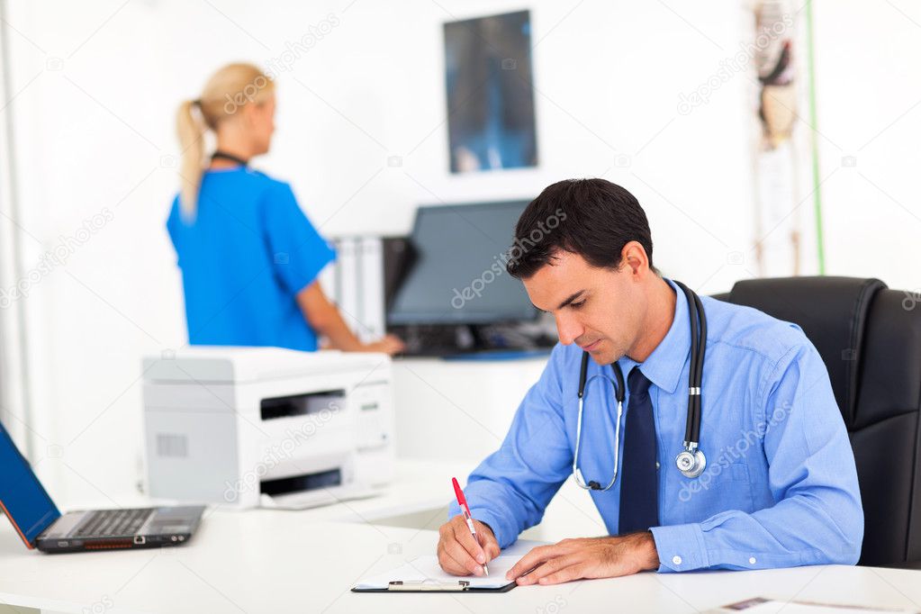 doctor writing medical report