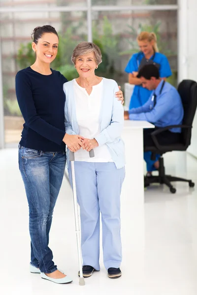 Beautiful daughter taking her elderly mother to doctor — Stock Photo, Image