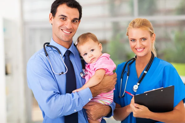 Pediatric doctor and nurse with baby Stock Image