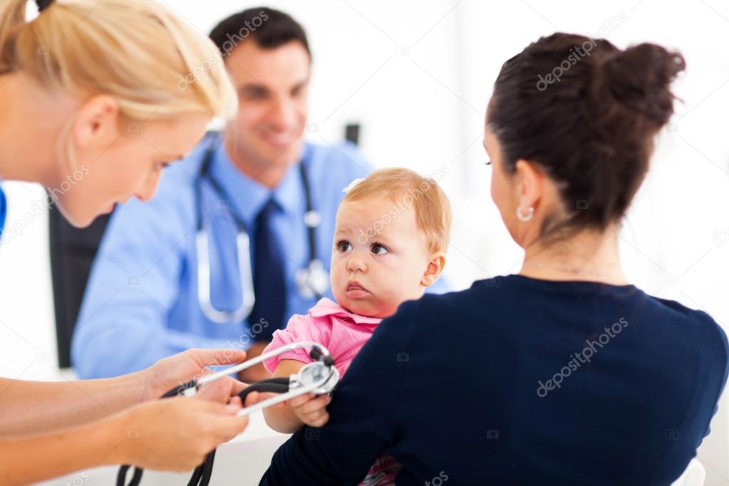 pediatric nurse playing with baby girl