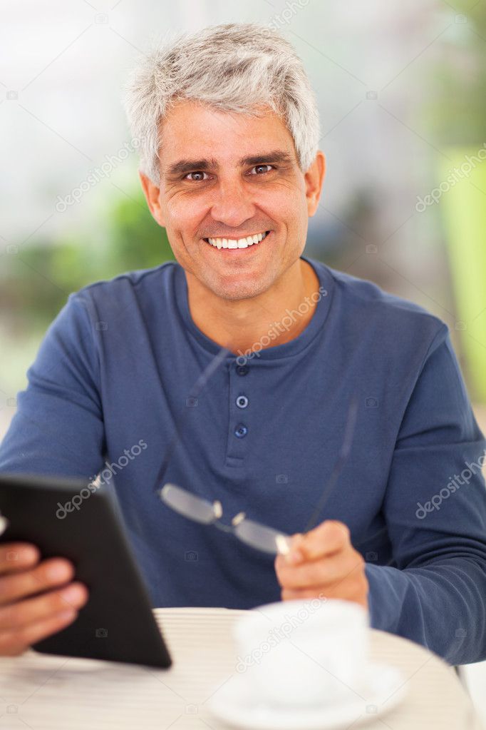 happy middle aged man with tablet computer