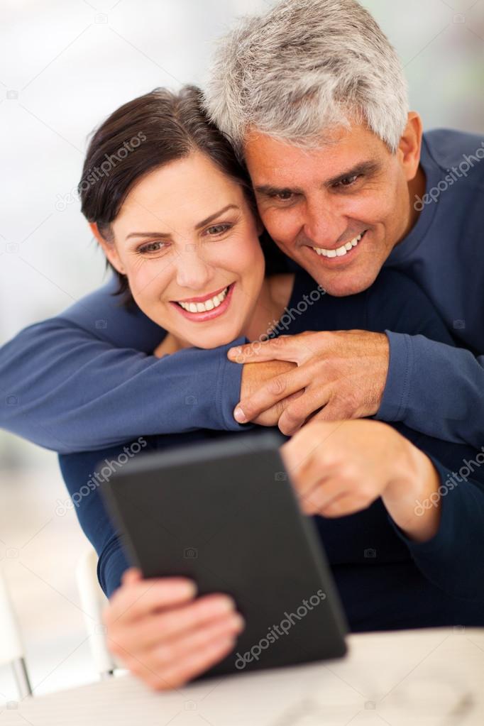 mature couple using tablet computer