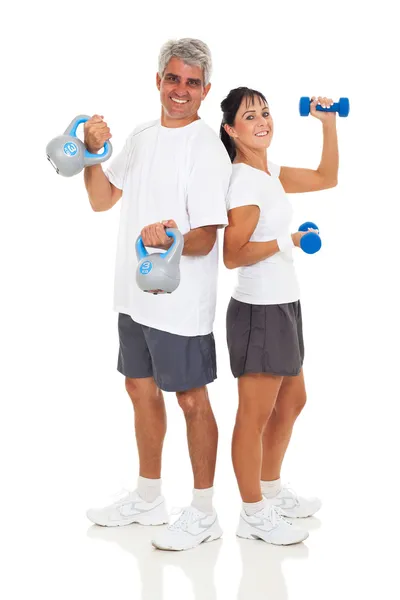 Senior couple posing with various gym equipment — Stock Photo, Image