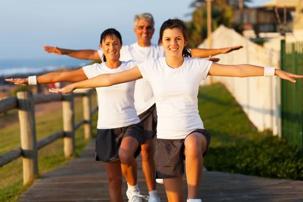 Modern active family exercising at the beach — Stock Photo, Image