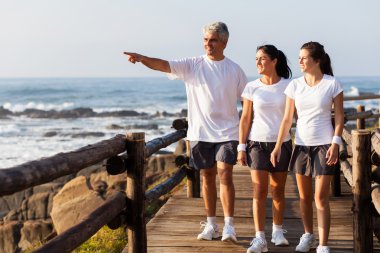 healthy family walking on beach