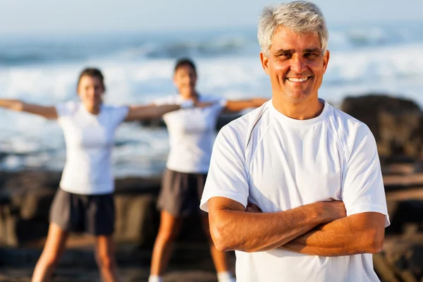 Fit reifer Mann am Strand mit Familie — Stockfoto