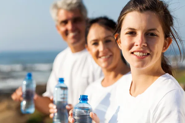 Fit family with water bottle after exercise — Stock Photo, Image