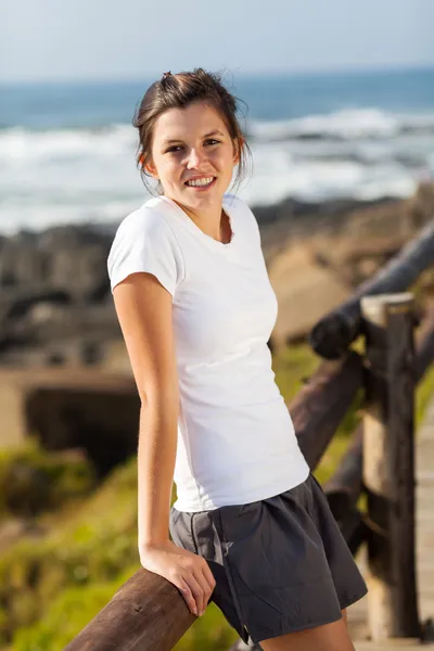 Pretty teen girl in sportswear at beach — Stock Photo, Image