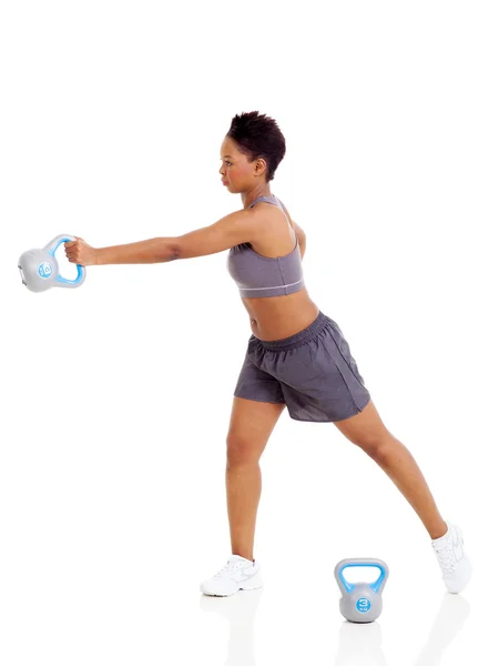 Young adult afro american woman doing swing exercise with kettle — Stock Photo, Image