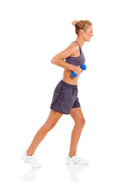 Side view of young woman exercising with dumbbells — Stock Photo, Image