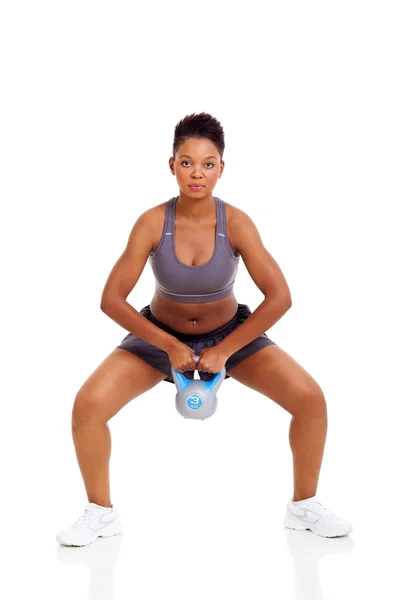 Young black female doing kettle bell exercise Stock Photo